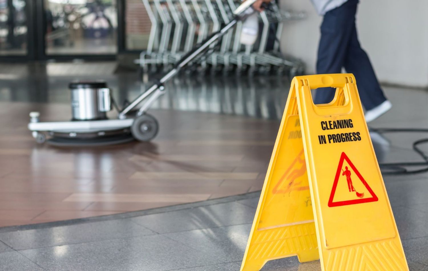 Cleaning in progress sign with a person buffering a floor